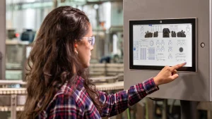 16x9 woman wearing protective goggles in factory setting RA.2400
